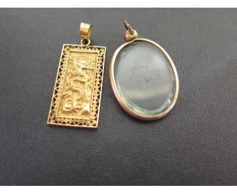 Two pendants - To include one of oriental design - Stamped 18K - Length 4.4cms - Weight approx 6.0gms - Together with a photo