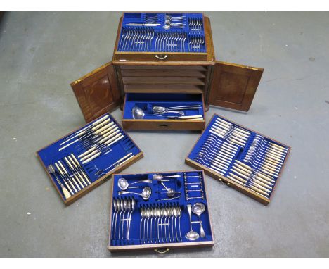 A canteen of cutlery marked 1897, in a light oak cabinet with five drawers all with recessed brass handles, containing a larg