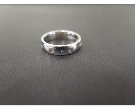 A bespoke platinum sapphire and diamond band ring  - The circular sapphire and brilliant-cut diamonds inset to the plain band