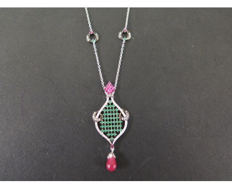 An emerald, ruby and white gem pendant necklace - Of openwork lattice design suspending a ruby briolette to the belcher-link 