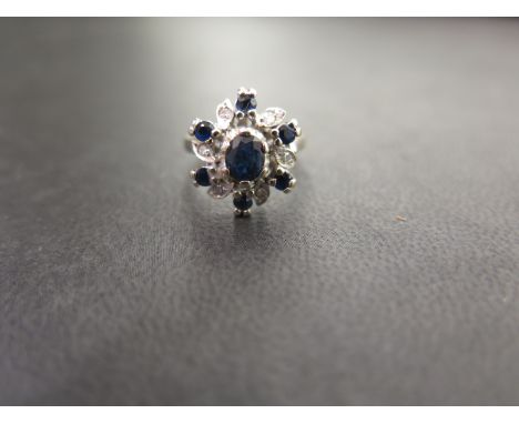 A sapphire and diamond cluster ring - Stamped 18ct - Ring size K - Weight approx 5.2gms
Condition Report: Good - With light s