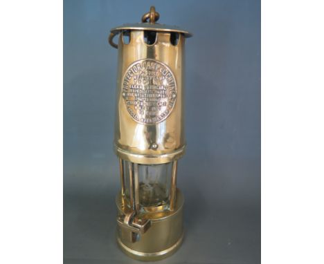 A brass miners lamp with label to front for Protector Lamp and Lighting Eccles Manchester - Height 26cm x 8 cm 
Condition rep