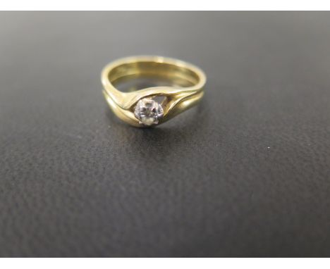 A diamond single-stone ring - Of twist design to the grooved band - With marks indicating 18ct gold - Ring size M - Weight ap