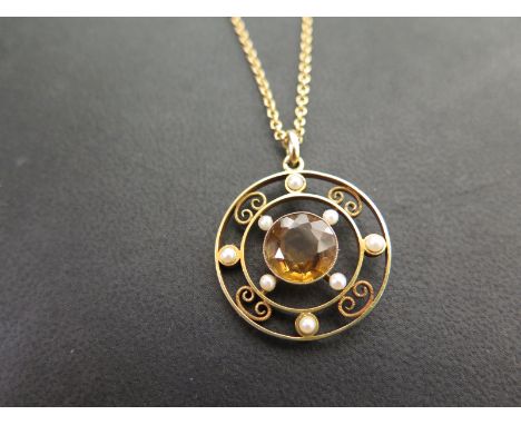 An early to mid 20th century 9ct gold citrine and seed pearl openwork pendant - Suspended from a belcher-link chain - Length 