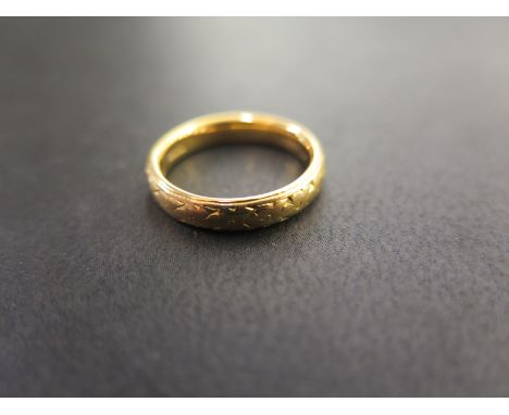 A 22ct gold textured band ring - Hallmarked London - Ring size K 1/2 - Weight approx 5.4gms
Condition Report: Good - With lig