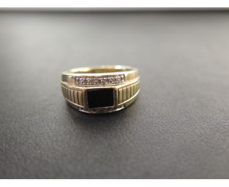 An onyx and diamond ring - Stamped 9ct - Ring size W 1/2 - Weight approx 7.6gms 
Condition Report: Good to fair - With light 