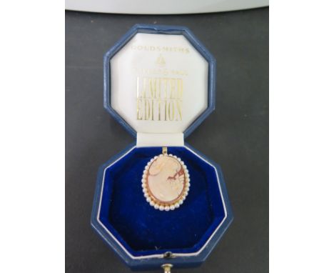 An 18ct gold shell cameo pendant/brooch - Within a cultured pearl surround - Hallmarked Birmingham - Length 5cms - Engraved t