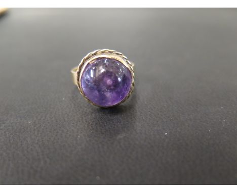 An amethyst cabochon ring - Stamped 9ct - Ring size S - Weight approx 8.2gms
Condition Report: Good to fair - With light surf