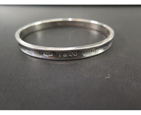 TIFFANY & CO - a silver bangle - Stamped 1997 Tiffany & Co 925 - Inner diameter approx 6.6cms - Weight approx 33.0gms
Conditi