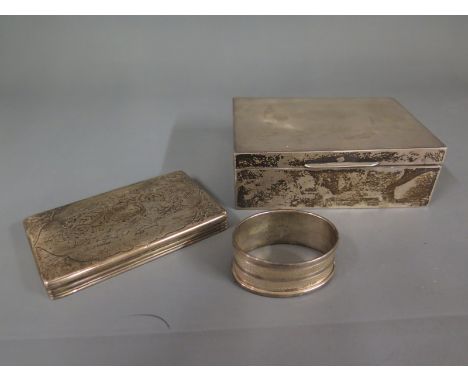 A silver rectangular cigarette box with engine turned design 11cm x 9cm, a similar napkin ring and a Victorian silver oblong 