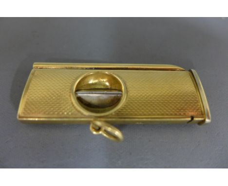 A 9ct yellow gold cased cigar cutter with engine turned decoration marked Birmingham 1959