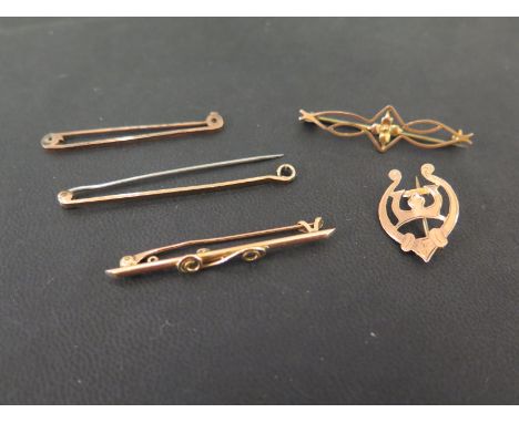 A swirl bar brooch - Stamped 15ct - Length 4.5cms - Weight 2.0gms - Together with four further brooches - With marks indicati