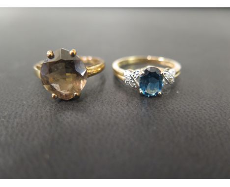 A 9ct gold smokey quartz single-stone ring - Size O - Together with a topaz and diamond dress ring - Size N 1/2 - Both hallma