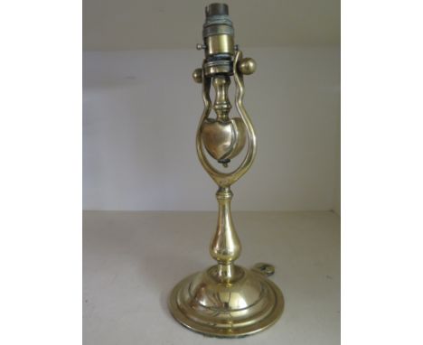 A brass Ship's lamp on a circular base fitted for electricity - Height 34cm