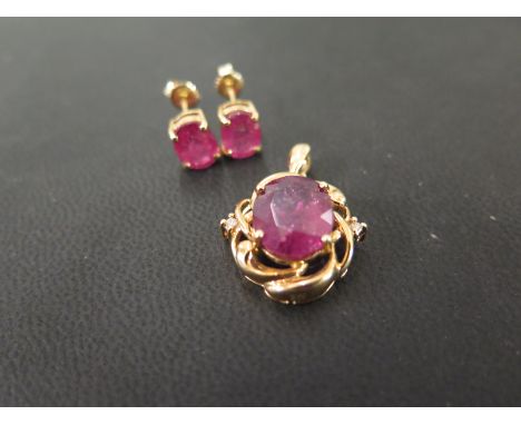 A ruby and diamond pendant - Together with a pair of ruby ear studs - Earrings with marks indicating 18ct gold - Length of pe