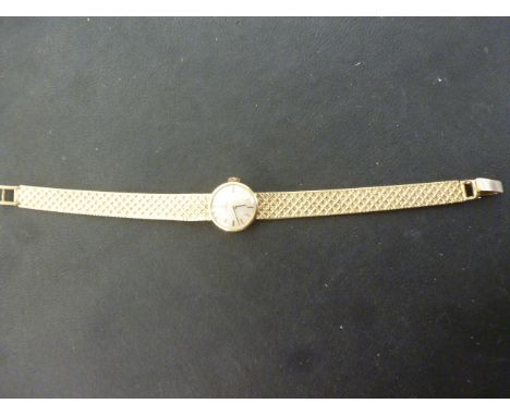 A 1950's Omega 9ct gold Ladies cocktail watch having metallic dial with stick markers and pencil hands, waffle weave bracelet