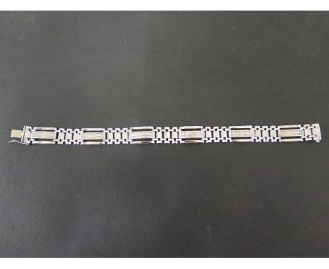 A diamond bracelet - Designed as six panels, each set with two rows of square-shape diamonds, to the fancy spacer-links and p
