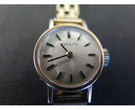 A 9ct gold cased ladies Tissot wristwatch on 9ct gold strap, baton markers to silvered dial - Total approx weight 14.6 grams
