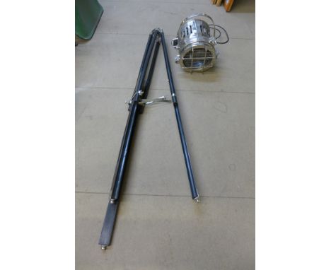 A chrome theatre style light on tripod stand