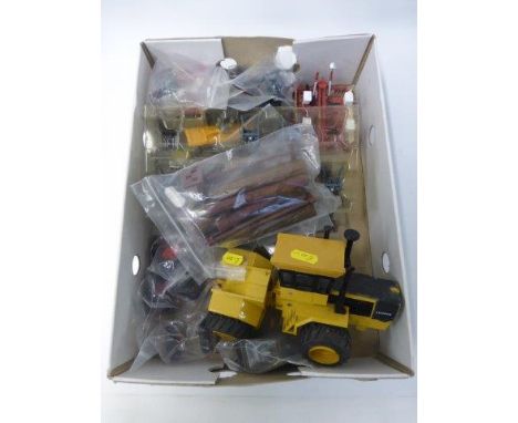 A box of assorted die cast model tractors, tractor parts and accessories.