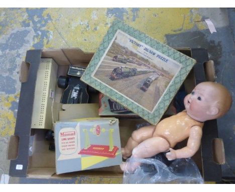 A box of assorted collectables, including a Victory Atlantic Coast Express jigsaw, a Mamod line shaft, and a bisque headed do