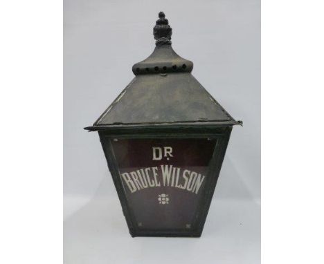 An early square tapering street lightbox lantern advertising a surgeon and physician - Dr. Bruce Wilson. 