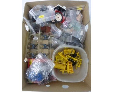 A box of assorted die cast tractor parts and accessories.