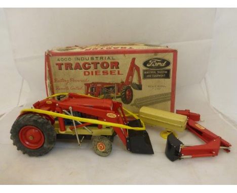 A boxed Cragstan Japanese tinplate battery powered scale model of a Ford tractor, in original box. 