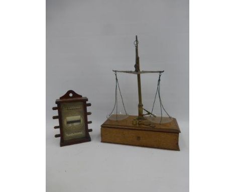 A small desktop calendar and a set of Edwardian oak and brass mounted scales.