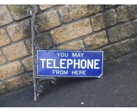 A "You May Telephone From Here" double sided enamel sign on original metal bracket, 22 x 9" (Sign only).