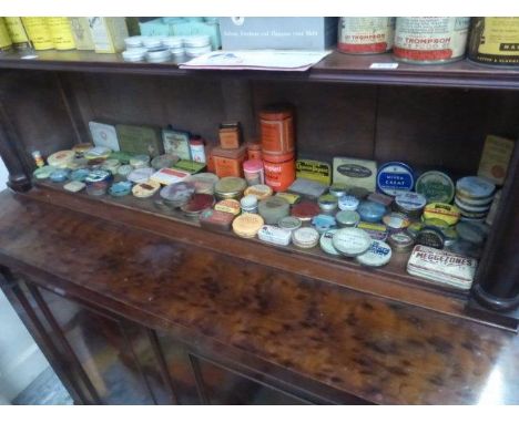 A shelf full of pharmaceutical products and ointment tins etc.