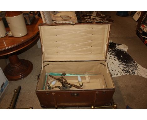 A wooden and metal bound travelling trunk and contents of light fitting, shooting stick, soda syphon etc.