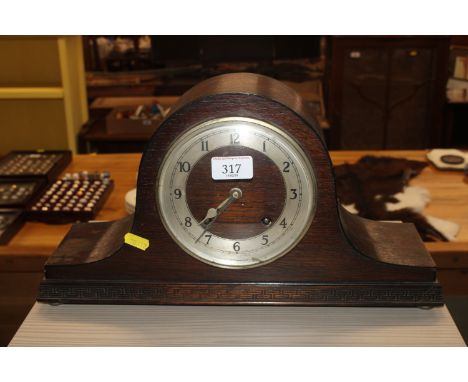 An oak cased twin hole mantel clock 