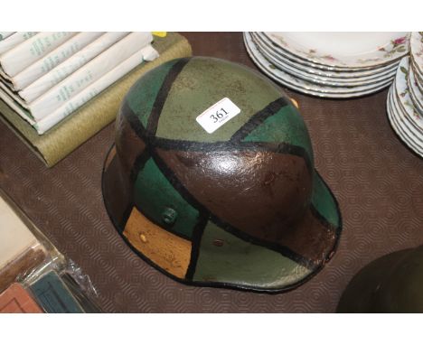 A German WWI 1916 patent helmet with camo paint finish
