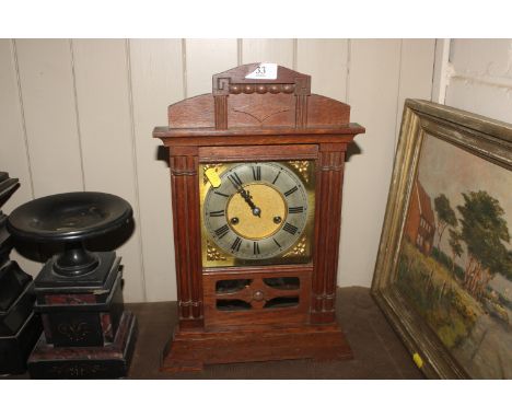 An oak cased two hole mantel clock 
