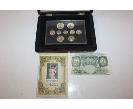 A silver and gilt plated 1953 Coronation coin set, boxed with certificate ands a &pound;1 Beale note