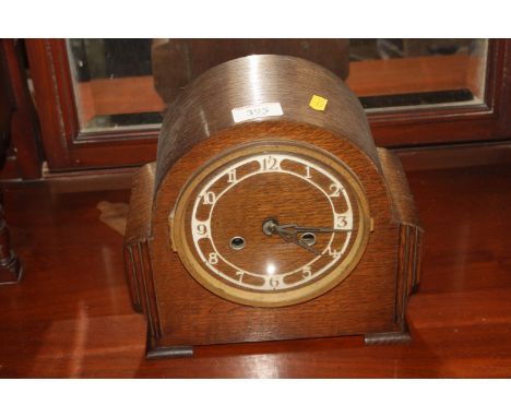 An oak cased Art Deco two hole mantel clock 