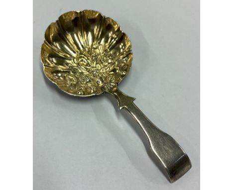 A George III chased silver caddy spoon. Birmingham 1814. By Ledsam & Vale. Approx. 8 grams. Est. £60 - £80.