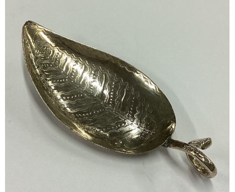A George III silver bright-cut leaf shaped caddy spoon. London 1809. By Edward Mayfield. Approx. 10 grams. Est. £60 - £80.