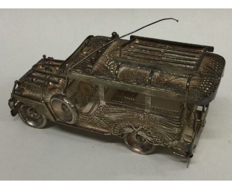 A large silver filigree model of a car. Approx. 140 grams. Est. £200 - £300.