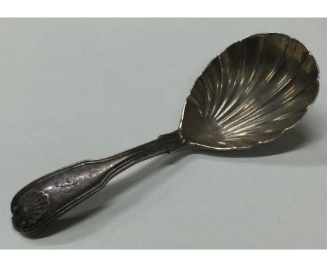 A Georgian silver caddy spoon with fluted bowl. London 1813. By WC. Approx. 28 grams. Est. £30 - £50.