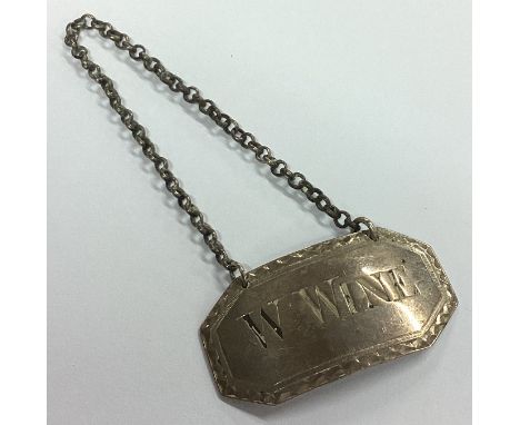 A rare Georgian silver wine label for 'White Wine'. London. By IP&IH. Approx. 10 grams. Est. £50 - £80.
