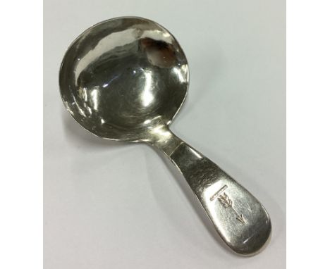A plain George III crested silver caddy spoon. London 1815. By Sarah & John William Blake. Approx. 13 grams. Est. £50 - £80.