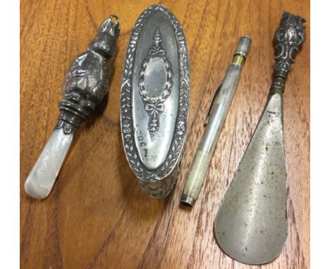An old Peter Rabbit silver rattle together with a thermometer etc. Est. £20 - £30.