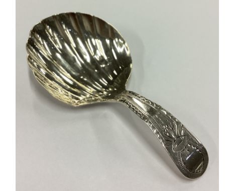 A large George III silver shell back caddy spoon. London 1832. Approx. 6 grams. Est. £50 - £80.