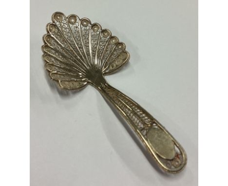 An unusual filigree silver caddy spoon. Circa 1800. Approx. 5 grams. Est. £30 - £50.
