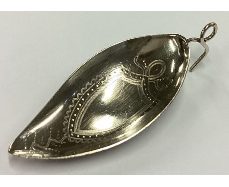 A George III silver bright-cut leaf shaped caddy spoon. London 1815. Approx. 11 grams. Est. £60 - £80.