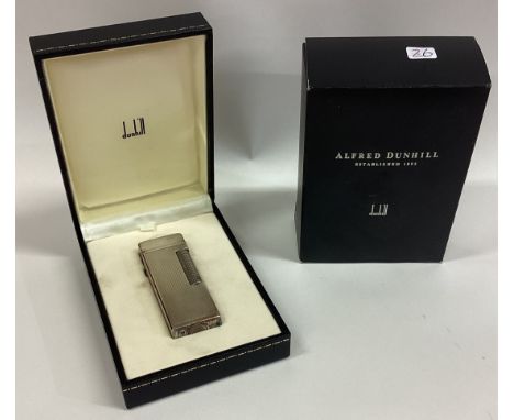 DUNHILL: A good boxed engine turned lighter contained within a fitted box together with paperwork. Est. £100 - £150.