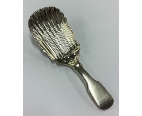 DUBLIN: A rare George III Irish silver fluted caddy spoon. 1815. By Matthew West. Approx. 9 grams. Est. £80 - £120.