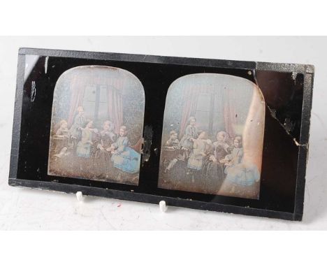 An Antoine Claudet tinted stereoscopic portrait daguerreotype of a family group, together with a beechwood stereoscopic slide